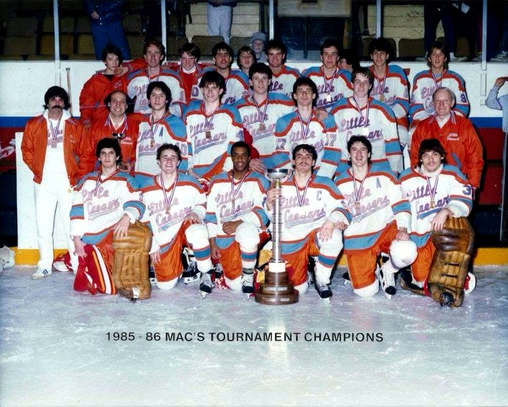 The 1985-86 Detroit Little Caesars team photo on the ice with their MAC’s Tournament trophy