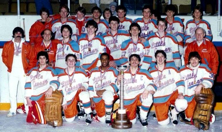 The 1985-86 Detroit Little Caesars team photo with their MAC's Tournament trophy